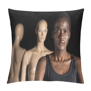 Personality  Attractive Young African American Woman Looking At Camera While Standing Near Dummies On Black Pillow Covers