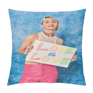 Personality  Cheerful Young Gay Activist In Baseball Cap And Pink Pants Smiling While Holding Placard With Love Is Love Words During Pride Month On Mottled Blue Background  Pillow Covers