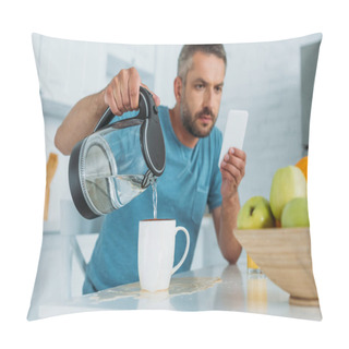 Personality  Selective Focus Of Man Overfilling Cup With Water While Sitting At Kitchen Table And Using Smartphone Pillow Covers