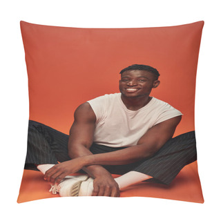 Personality  Young African American Male Model In White Tank Top And Pants Sitting An Smiling At Camera On Red Pillow Covers