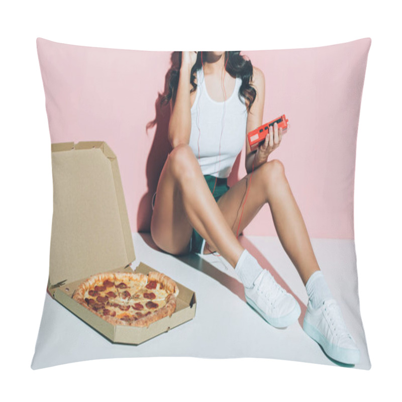 Personality  cropped shot of smiling woman with retro music player and delivery box with pizza on pink background pillow covers