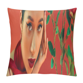 Personality  Portrait Of Youthful And Alluring Asian Woman With Bold Makeup And Expressive Gaze Holding Hand Near Face And Looking At Camera Near Flowers On Red Background, Trendy Spring, Generation Z, Banner Pillow Covers