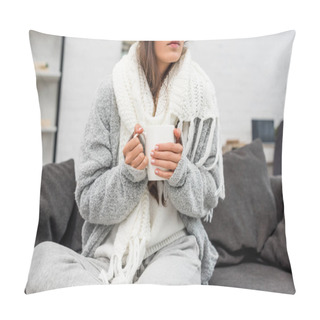 Personality  Cropped Shot Of Sick Young Woman In Warm Clothes Holding Cup Of Hot Drink While Sitting On Couch At Home Pillow Covers