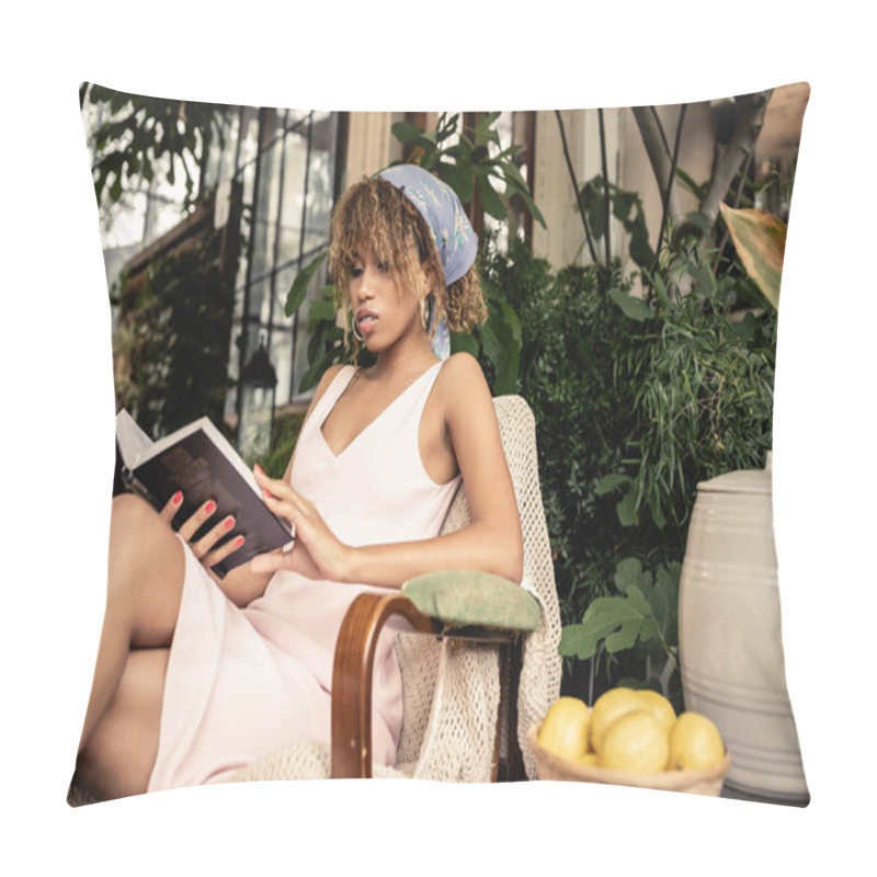 Personality  Trendy young african american woman in summer outfit reading book while sitting near blurred lemons in indoor garden, woman wearing summer outfit surrounded by tropical foliage, summer concept  pillow covers