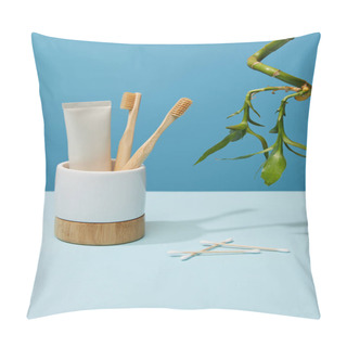Personality  Holder With Bamboo Toothbrushes, Toothpaste In Tube, Ear Sticks And Bamboo Stem On Table And Blue Background Pillow Covers