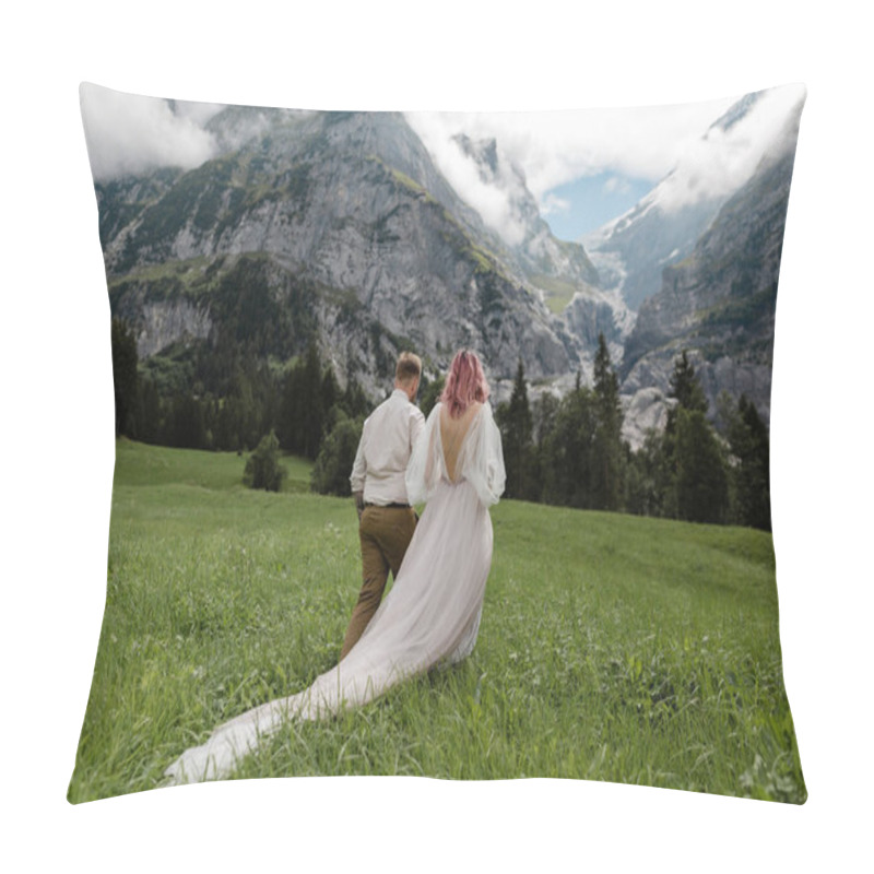 Personality  Rear View Of Bride In Wedding Dress And Groom Holding Hands And Walking On Green Mountain Meadow In Alps Pillow Covers