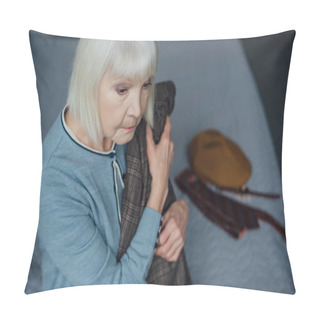 Personality  Upset Senior Woman With Grey Hair Sitting On Bed And Holding Jacket At Home Pillow Covers