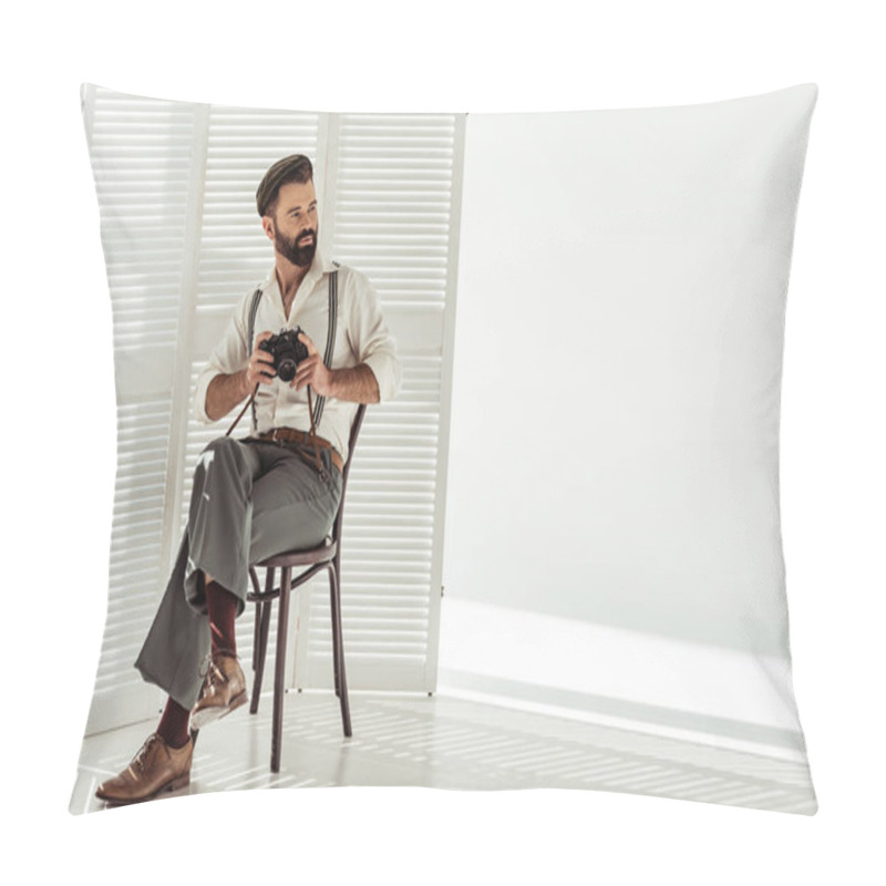 Personality  handsome bearded man sitting on chair and holding vintage film camera pillow covers