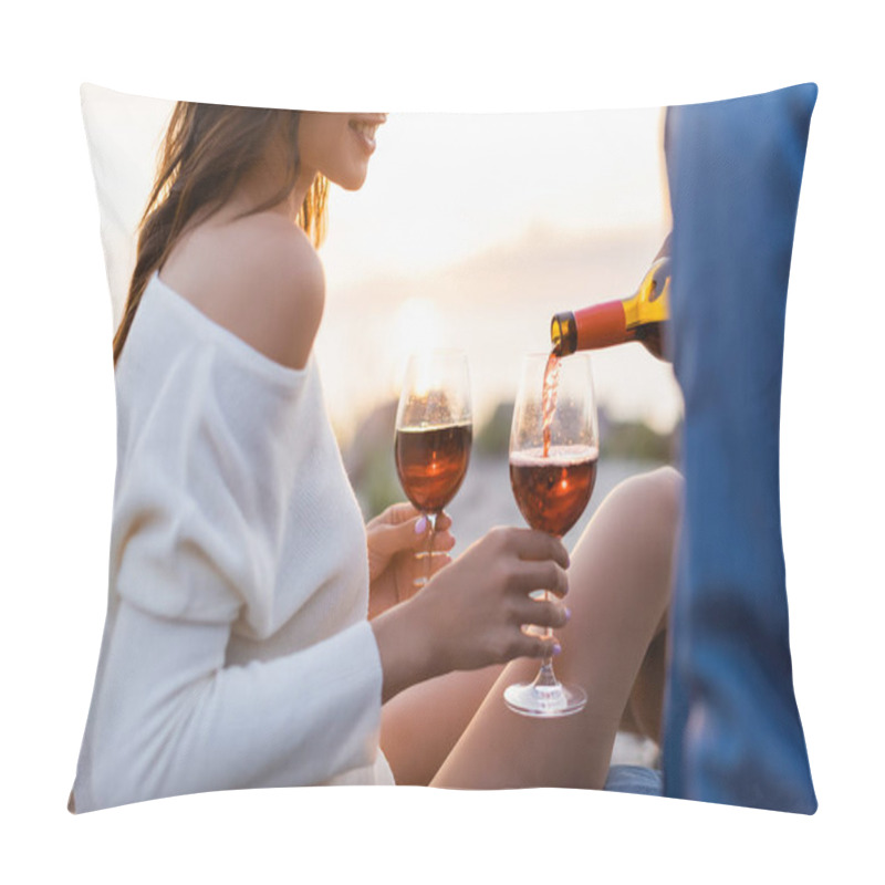 Personality  Cropped view of woman holding glasses while boyfriend pouring wine on beach at evening pillow covers