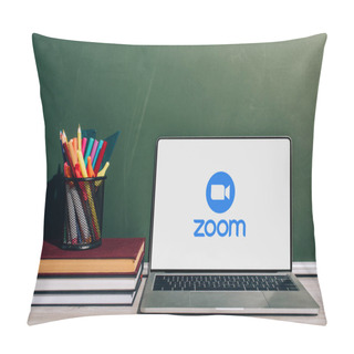 Personality  KYIV, UKRAINE - JULY 7, 2020: Laptop With Zoom Website Near Pen Holder With Stationery On Stack Of Books Near Green Chalkboard Pillow Covers