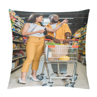 Personality  African American Woman With Shopping List Pointing By Finger To Boyfriend With Shopping Trolley In Supermarket  Pillow Covers