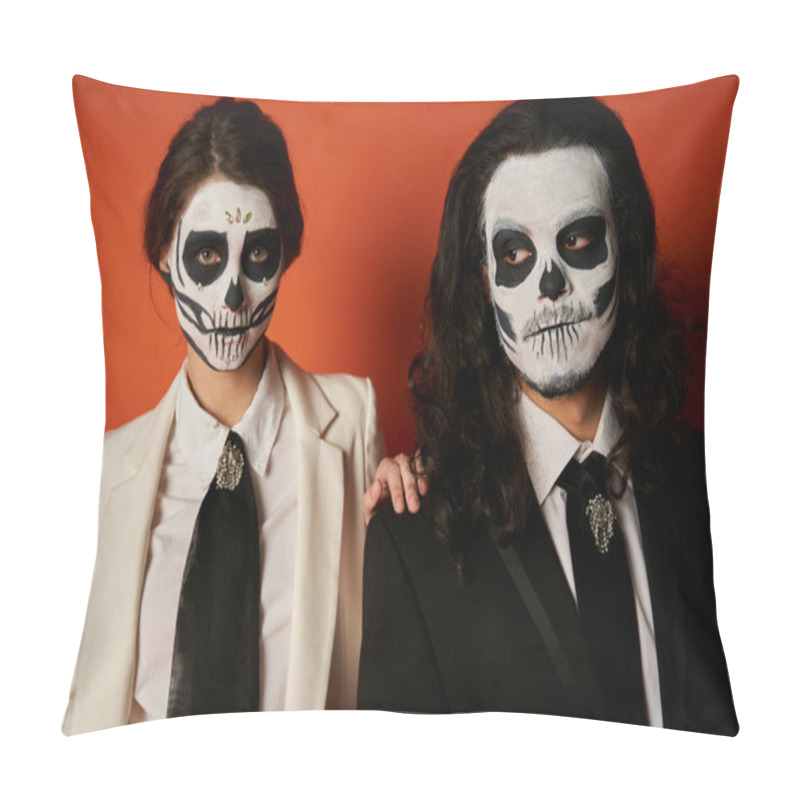 Personality  elegant dia de los muertos couple in skull makeup, woman looking at camera near spooky man on red pillow covers