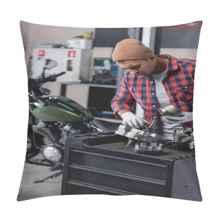 Personality  Young Technician In Plaid Shirt And Beanie Checking Parts Of Disassembled Gearbox Near Motorbike On Blurred Background Pillow Covers