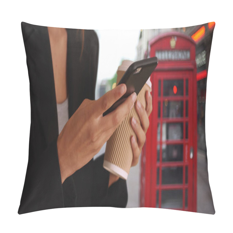 Personality  Close up of female hands text messaging on smartphone while downtown in London pillow covers