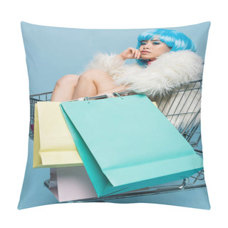 Personality  Trendy Asian Woman In Bright Wig Holding Shopping Bags While Sitting In Cart On Blue Background  Pillow Covers