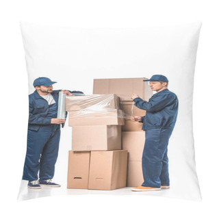 Personality  Two Movers Wrapping Cardboard Boxes With Roll Of Stretch Film On White Pillow Covers