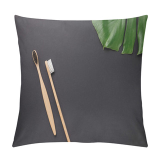 Personality  Zero Waste And Without Plastic Concept. Two Wooden Bamboo Eco Friendly Toothbrushes And Green Leaves Monstera On Black Background. Flat Lay, Top View, Copy Space. Pillow Covers