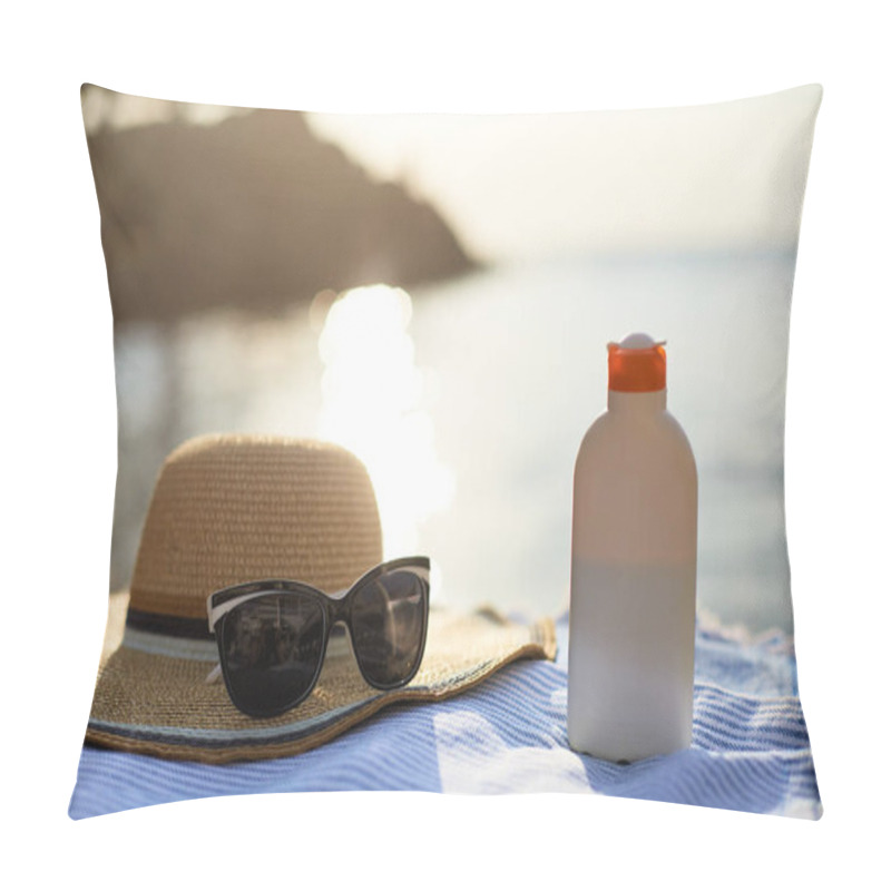 Personality  Suntan cream bottle and sunglasses on beach towel with sea shore on background. Sunscreen on deck chair outdoors on sunrise or sunset. Skin care and protection concept. Golden tan. pillow covers