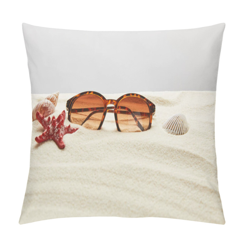 Personality  brown stylish sunglasses on sand with red starfish and seashells on grey background pillow covers