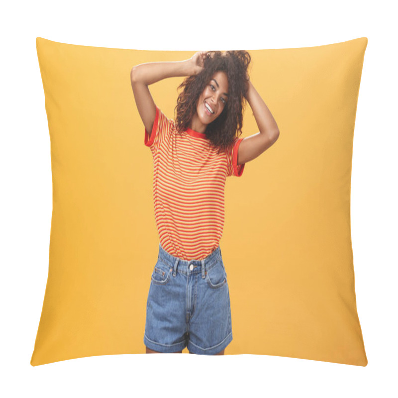 Personality  Time start living life fullest. Joyful optimistic woman having fun during vacation tilting head touching curly hair and enjoying summer sunshine in trendy striped t-shirt and shorts over orange wall pillow covers