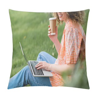 Personality  Cropped View Of Cheerful Freelancer With Curly Hair Holding Paper Cup And Using Laptop While Sitting On Grass  Pillow Covers