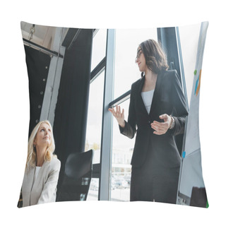 Personality  Young Manager Talking To Mature Businesswoman While Standing Near Flipchart And Showing Explain Gesture Pillow Covers