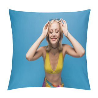 Personality  Pleased Young Woman In Yellow Bikini Top Adjusting Trendy Sunglasses Isolated On Blue Pillow Covers