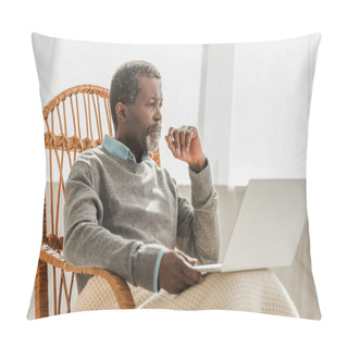 Personality  Dreamy African American Man Sitting In Wicker Chair With Laptop And Looking Away Pillow Covers