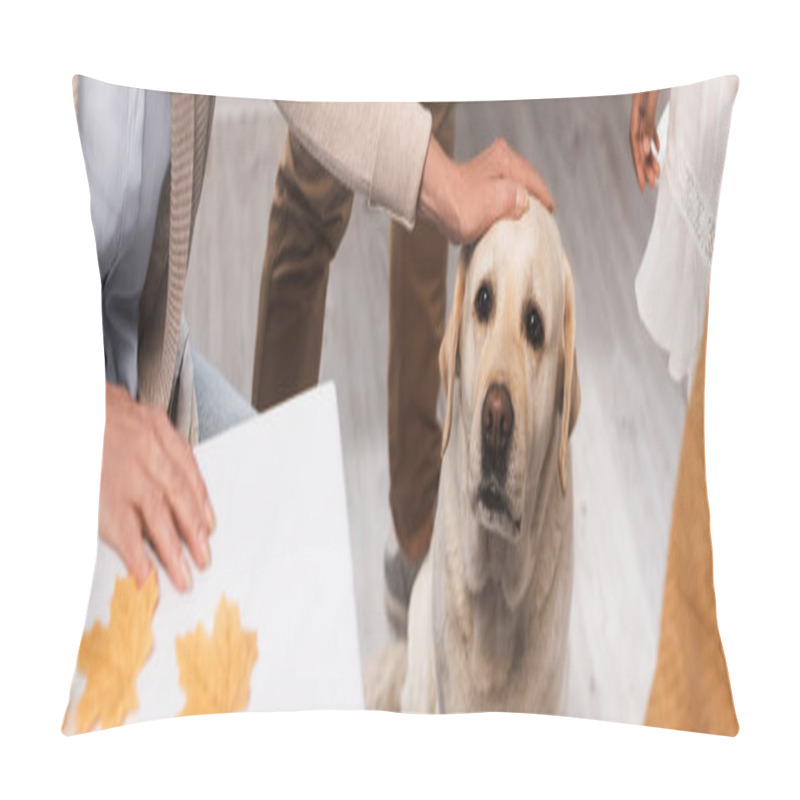 Personality  panoramic crop of senior woman stroking golden retriever near multicultural family on thanksgiving day, panoramic concept pillow covers
