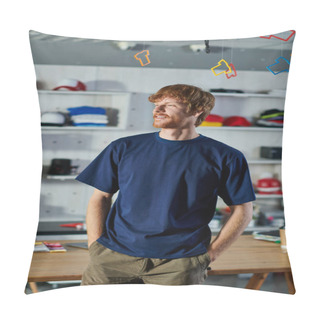 Personality  Young Redhead Designer In Casual Clothes Holding Hands In Pockets And Standing Near Working Table In Blurred Print Studio, Hands-on Entrepreneurship Concept  Pillow Covers