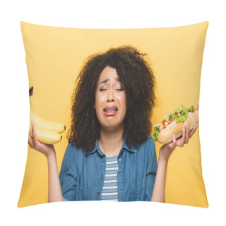 Personality  Upset African American Woman Choosing Between Fresh Bananas And Hot Dog Isolated On Yellow Pillow Covers