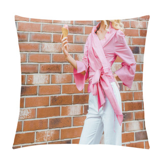 Personality  Cropped Shot Of Young Woman In Pink Holding Ice Cream In Front Of Brick Wall Pillow Covers
