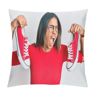 Personality  Young Latin Girl Holding Red Casual Shoes Angry And Mad Screaming Frustrated And Furious, Shouting With Anger. Rage And Aggressive Concept.  Pillow Covers