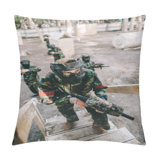 Personality  High Angle View Of Male Paintball Player In Goggle Mask With Marker Gun On Staircase While His Team Standing Behind Outdoors  Pillow Covers