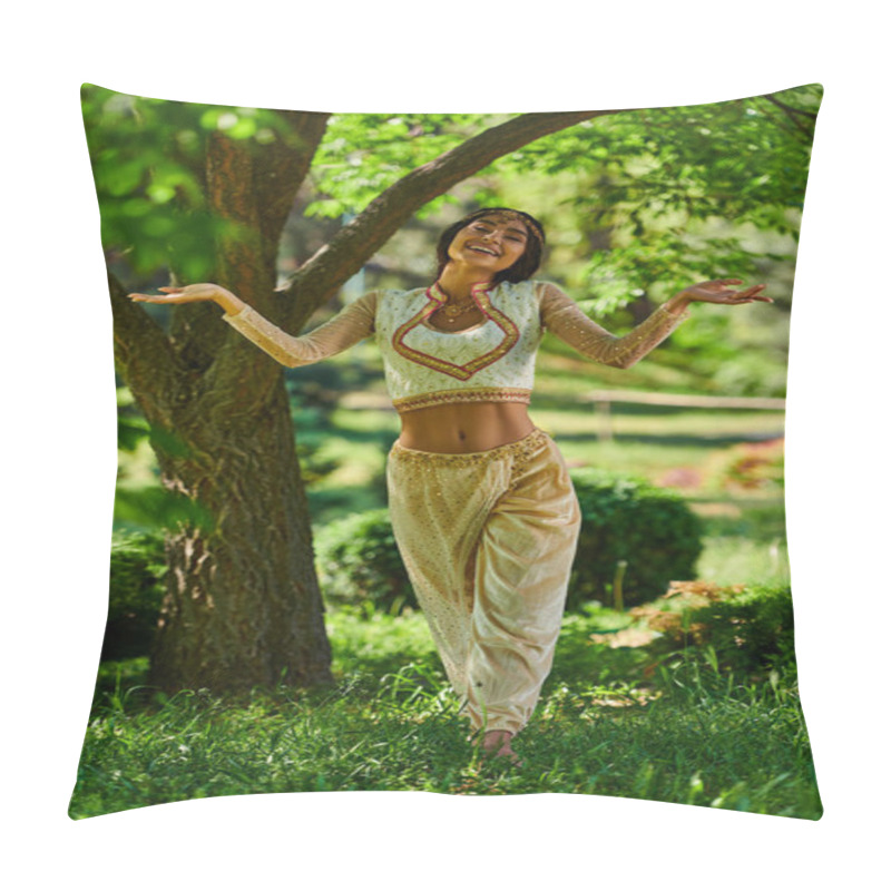 Personality  carefree indian woman in vibrant traditional attire dancing in summer park on lawn under tree pillow covers