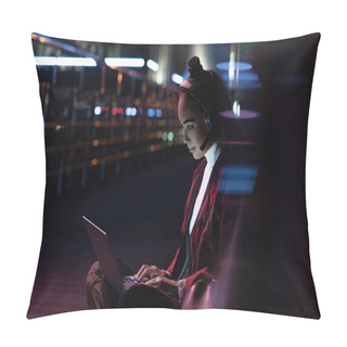 Personality  Attractive Asian Girl In Kimono Sitting And Using Laptop With Headphones On Street With Neon Light, City Of Future Concept Pillow Covers