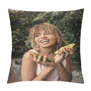 Personality  Positive Young African American Woman With Braces In Summer Dress Holding Fresh Papaya And Looking Away While Standing Near Blurred Plants In Orangery, Inspired By Tropical Plants, Summer Concept Pillow Covers