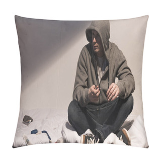 Personality  Addictive Man In Hoodie Holding Smoking Pipe While Sitting On Mattress In Dark Room Pillow Covers