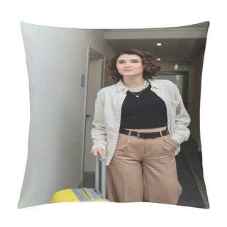 Personality  Young Woman With Wavy Brunette Hair, In Black Crop Top, White Shirt And Beige Pants Walking With Hand In Pocket And Yellow Suitcase Along Corridor In Contemporary Hotel  Pillow Covers