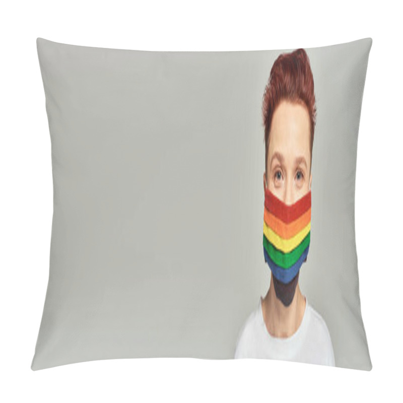 Personality  portrait of redhead queer person in rainbow colors medical mask looking at camera on grey, banner pillow covers