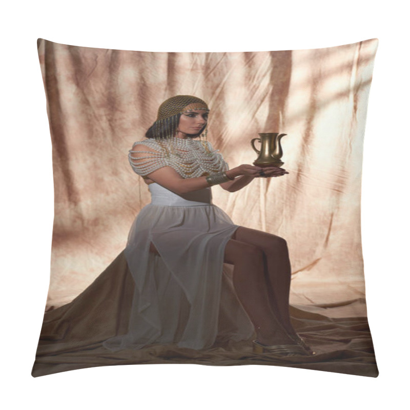 Personality  Woman in traditional egyptian outfit holding golden jug while sitting on abstract background pillow covers