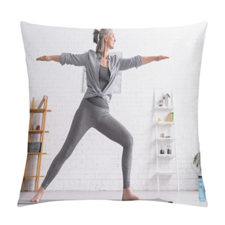 Personality  Middle Aged Woman In Sportwear Standing In Warrior Pose While Practicing Yoga At Home  Pillow Covers