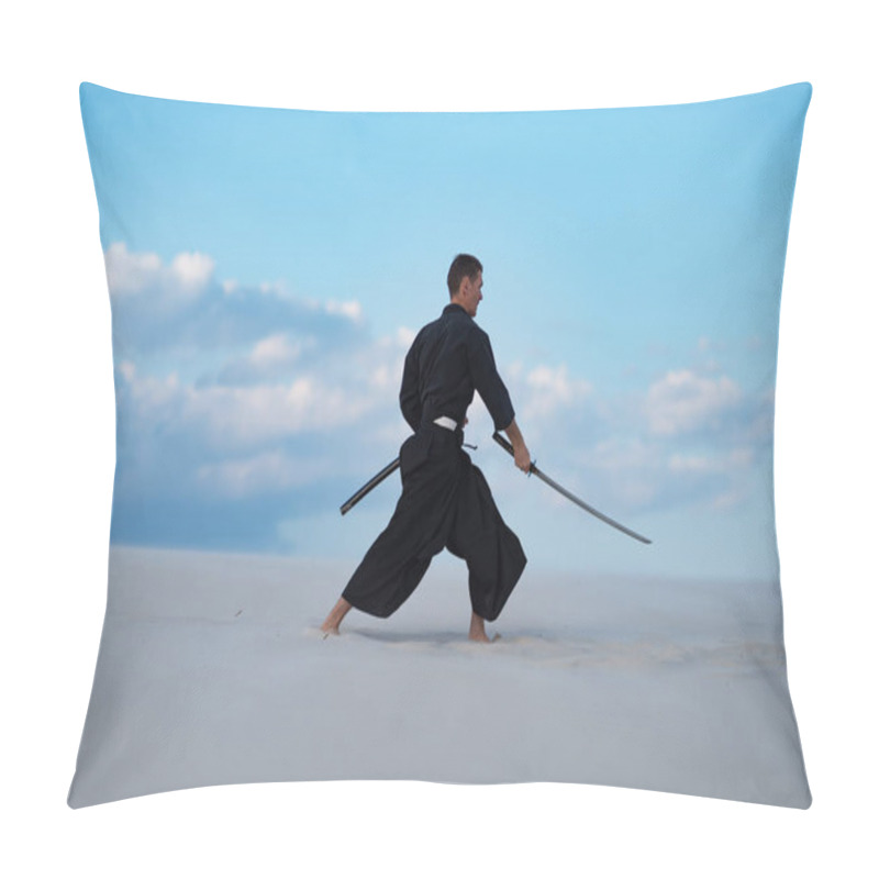 Personality  Focused man, in traditional Japanese clothes, with sword, katana, is training martial arts in desert during sunset - samurai on the blue cloudy sky background. Side view. pillow covers
