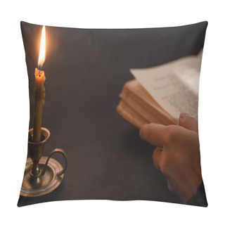 Personality  Cropped View Of Woman Holding Holy Bible Near Burning Candle In Dark Pillow Covers