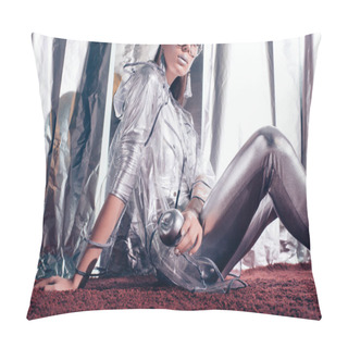 Personality  Stylish Young Woman In Silver Bodysuit And Raincoat Holding Silver Apple And Posing For Fashion Shoot On Metallic Background Pillow Covers