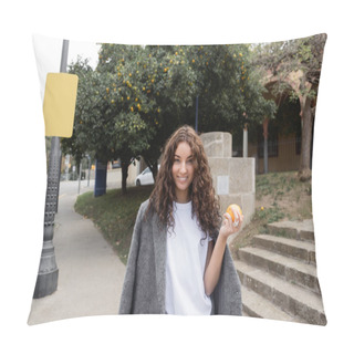 Personality  Smiling Young And Curly Woman In Warm Jacket Holding Fresh Orange And Looking At Camera While Standing On Blurred Urban Street At Background In Barcelona, Spain, Street Lamp, Motor Scooter Pillow Covers