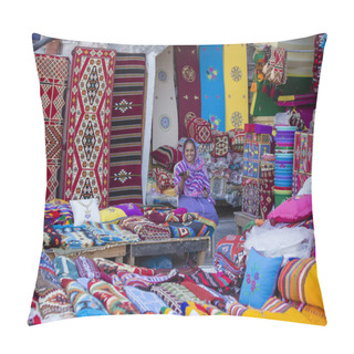 Personality  DOHA, QATAR - DECEMBER 25, 2017 : Female Trader At Souq Waqif Market In Doha, With Multicolour Carpets, Kilims And Other Items. Doha, Qatar Pillow Covers