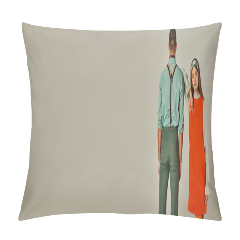 Personality  vintage style woman in orange dress looking at camera near man in suspenders on grey, banner pillow covers