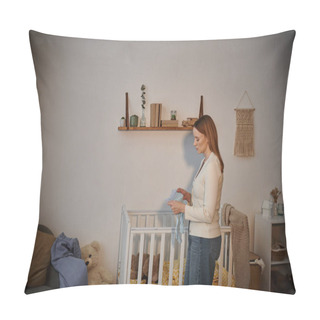 Personality  Side View Of Frustrated Woman Holding Baby Clothes Near Crib With Soft Toys In Nursery Room Pillow Covers