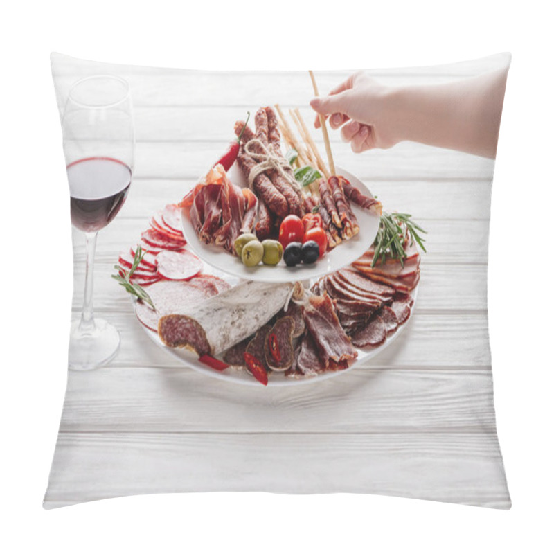 Personality  cropped shot of woman, glass of red wine and meat snacks on white wooden surface pillow covers